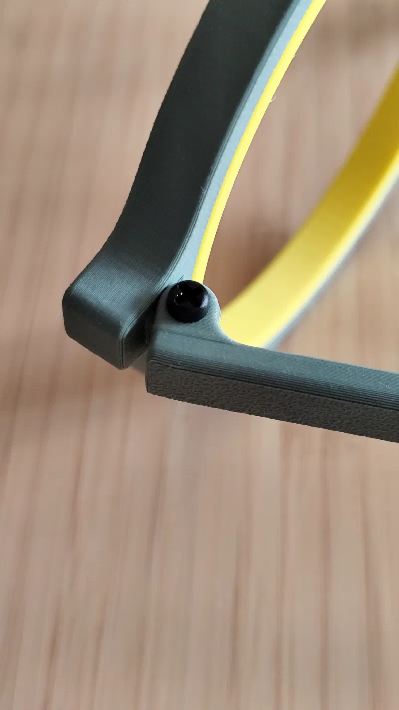 Close-up of glasses shaped hoop hinge mechanism.